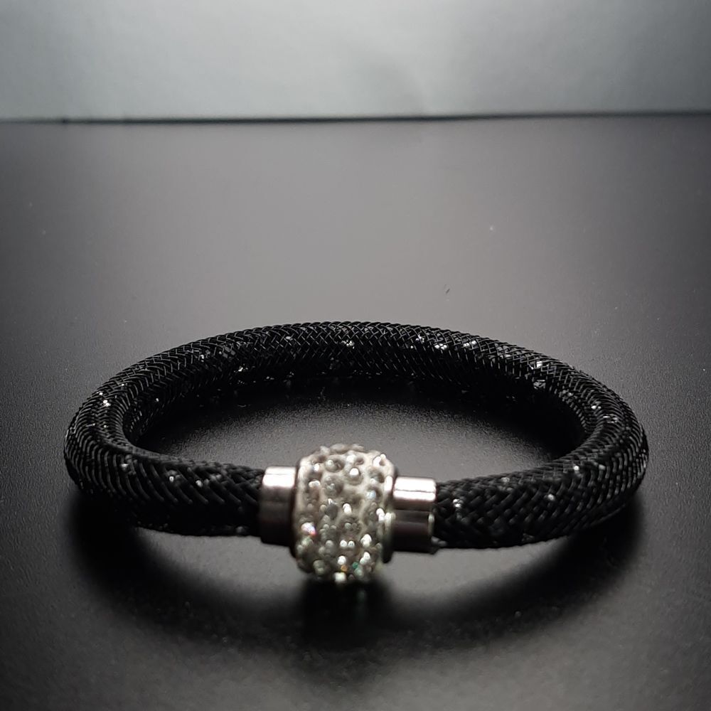 Vintage black rope like bracelet with silver sparkles.